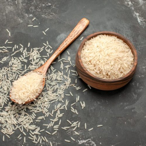top-view-from-afar-rice-spoon-bowl-rice-dark-table_140725-78800